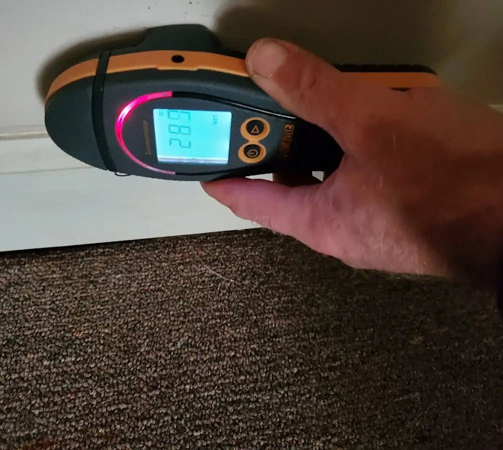 Moisture detection at baseboard during Storm Damage Restoration in Woodway
